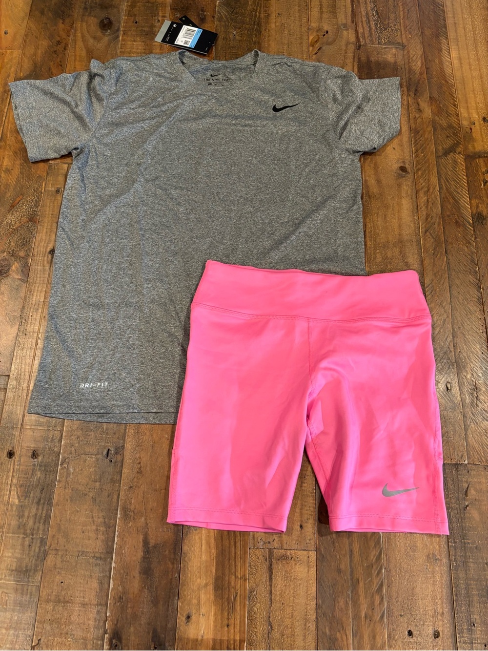 Nike Pink Women's Bike Shorts with Silver Swoosh and a Grey Nike Shirt